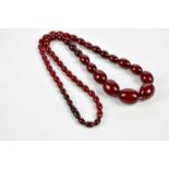 A strand of cherry amber coloured beads, approx weight 75.1g. Condition Report: As catalogued, the