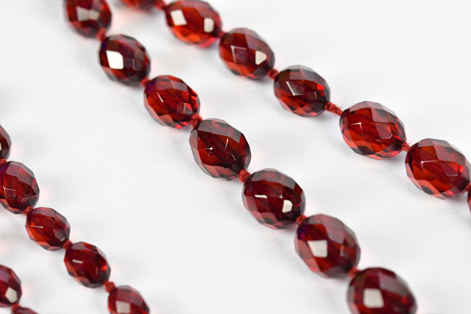 A cherry amber facet cut graduated bead necklace, length 88cm, approx 58.6g. - Image 3 of 5