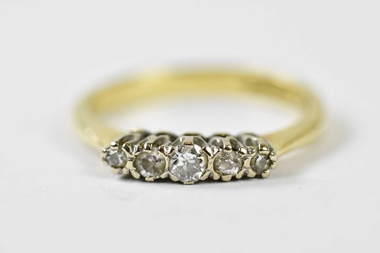 An 18ct yellow gold and tiny five stone graduated diamond ring, size M, approx. 3.1g.