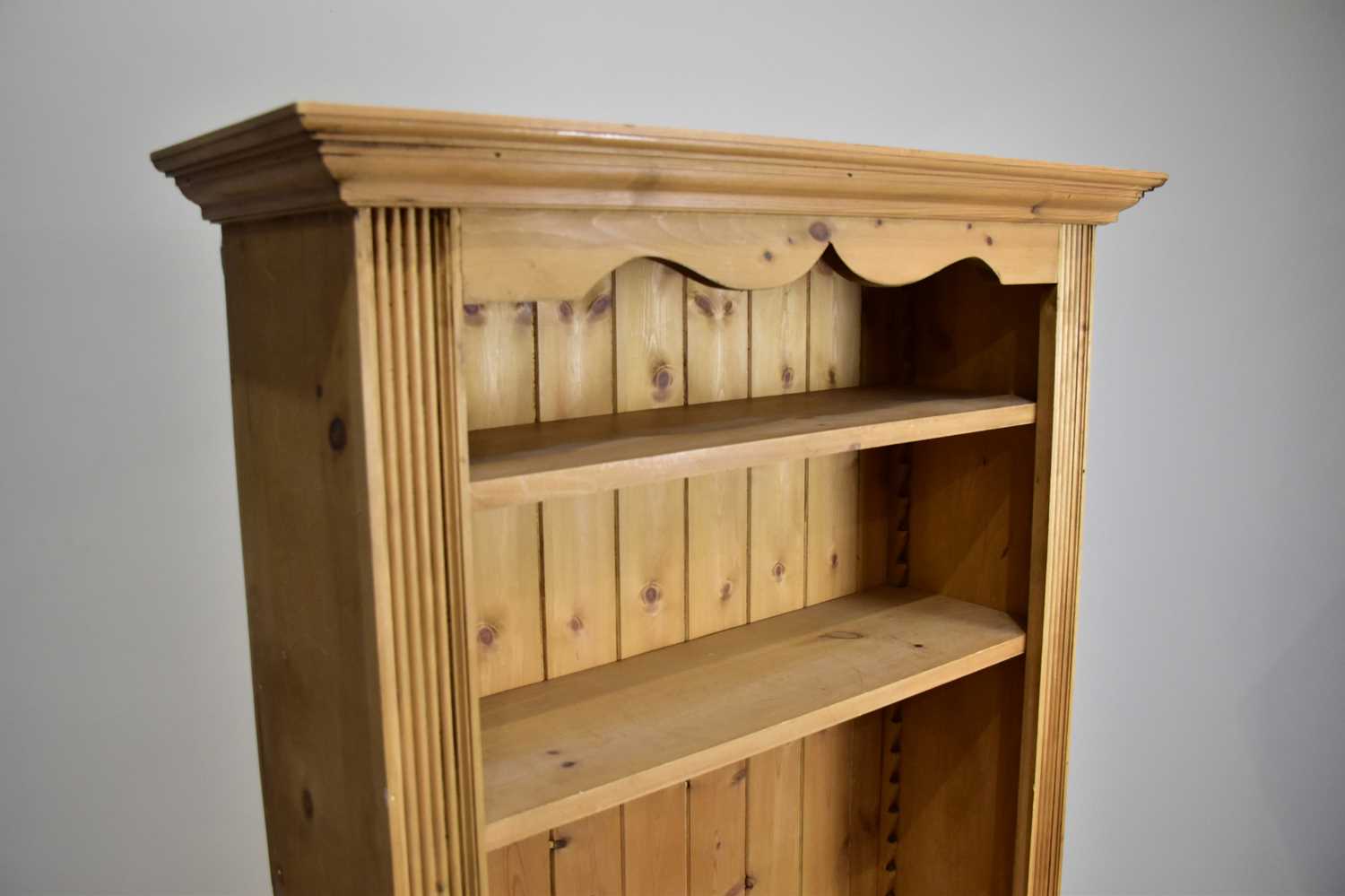 A modern pine bookcase with moulded cornice above an arrangement of four shelves, height 180cm, - Image 2 of 2