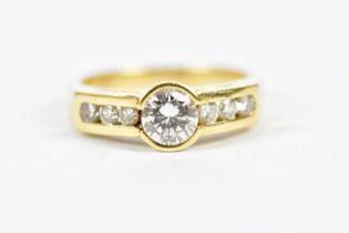 A yellow metal diamond set ring, the principal round brilliant cut stone weighing approx 1ct, with