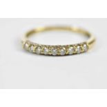 A 9ct yellow gold half eternity ring, set with nine principle stones and a melee of twnety stones,