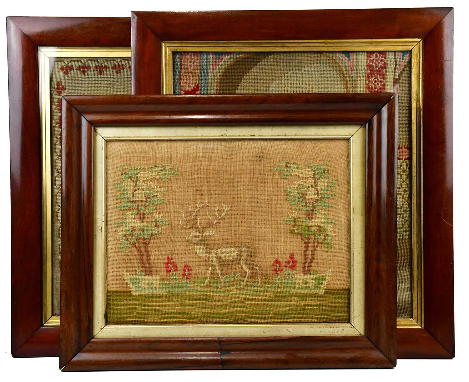 Three 19th century needlework pictures, including an example depicting a farm boy in landscape, 44 x