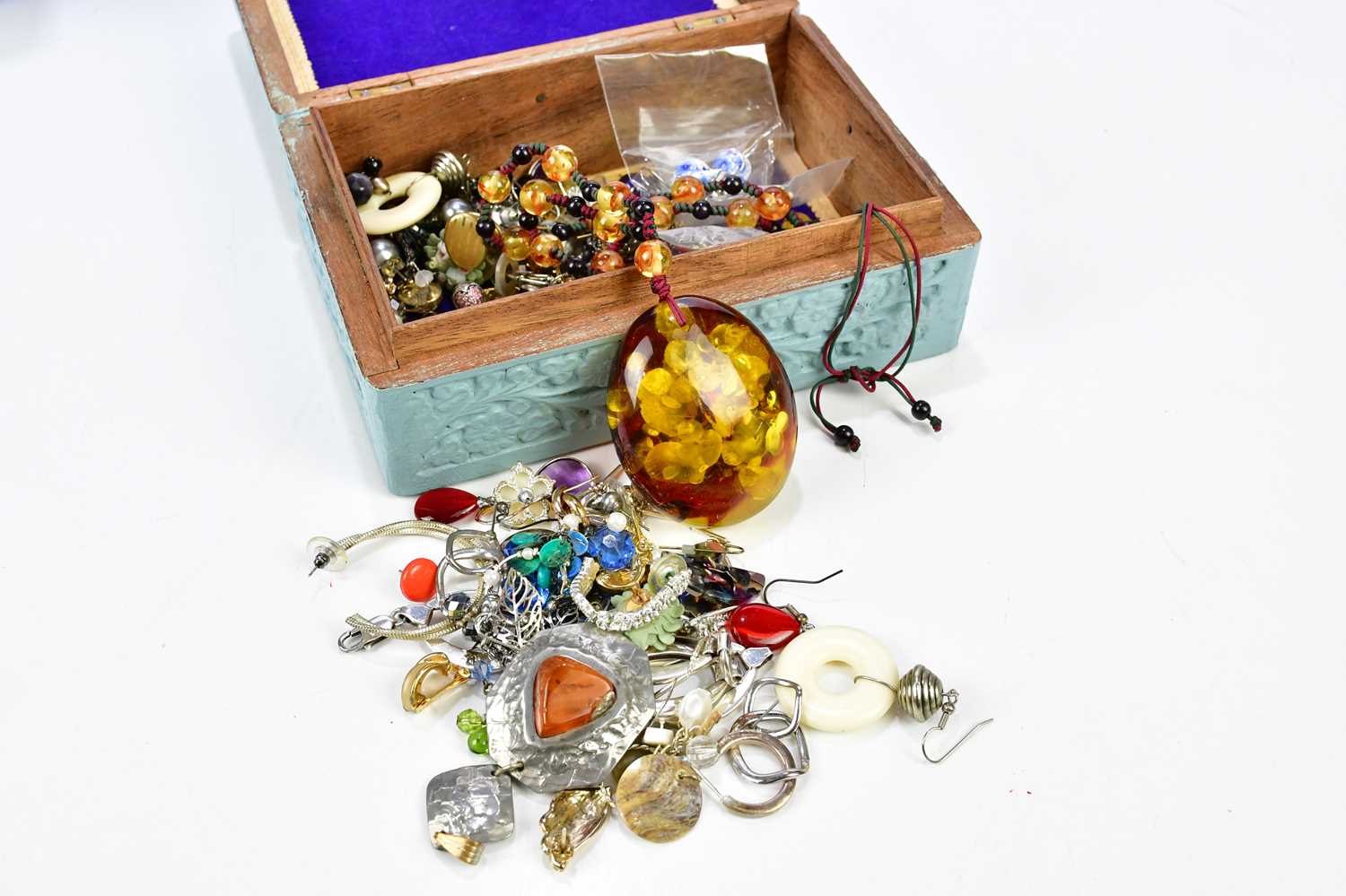 A group of costume jewellery, including an abstract silver bracelet, lucite pendant on chain,