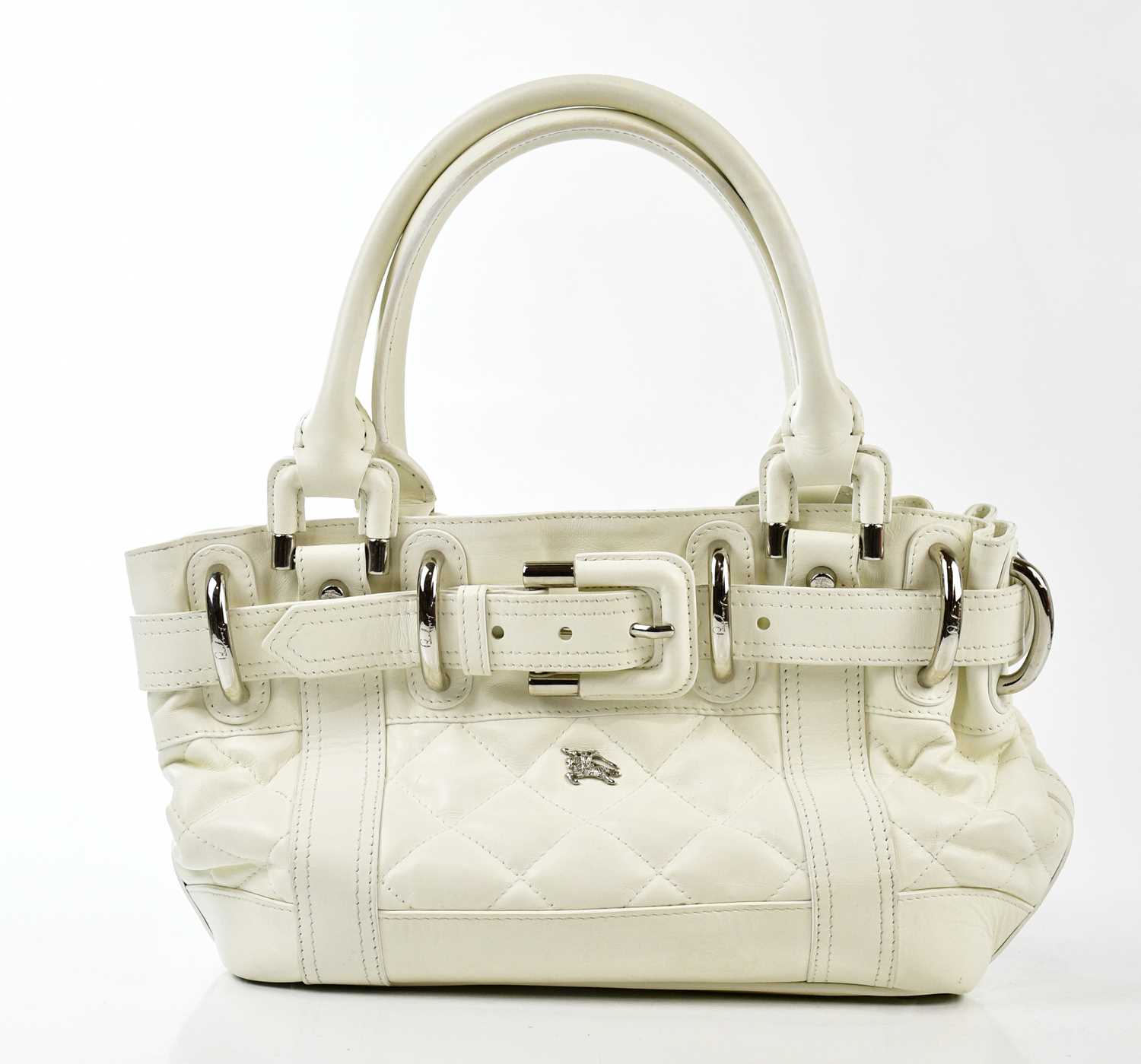 BURBERRY; a white calfskin leather quilted handbag with buckle embellishment, two top handles,