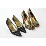 DOLCE & GABANNA; a pair of black snakeskin leather court shoes with diamante DG front bow detail,