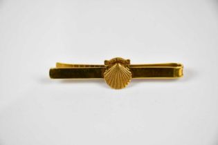 A 9ct yellow gold tie clip with applied shell, inscribed 'Ten Years Service', approx weight 8.7g.