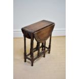 A reproduction oak drop-leaf gateleg dining table, height 68cm.