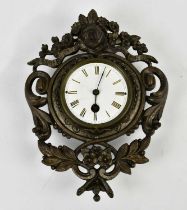 A cast metal wall clock with white enamel dial set with Roman numerals, height 27cm.