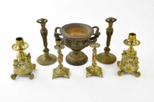 A 19th century cast metal model of a Warwick vase, two pairs of brass candlesticks, and a pair of