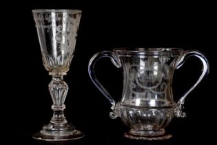 A 18th century glass twin handled pedestal vase with etched scrolling decoration and engraved