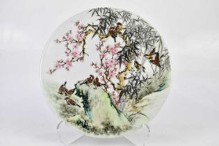 A Chinese handpainted Famille Rose dish decorated with prunus flowers and birds, diameter 40cm.
