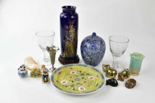 An assortment of oriental tourist items, including a carved shell, a decorative silver plated