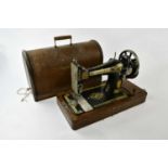 SINGER; an oak cased sewing machine.