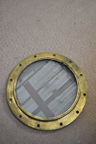 A large brass ship's porthole, diameter 53cm.