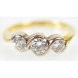 An 18ct yellow gold three stone graduated diamond ring, the central stone weighing approx. 0.25ct,