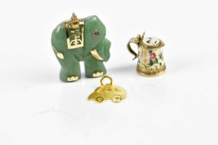 A Chinese inspired carved green stone pendant modelled as an elephant with yellow metal mounts, a