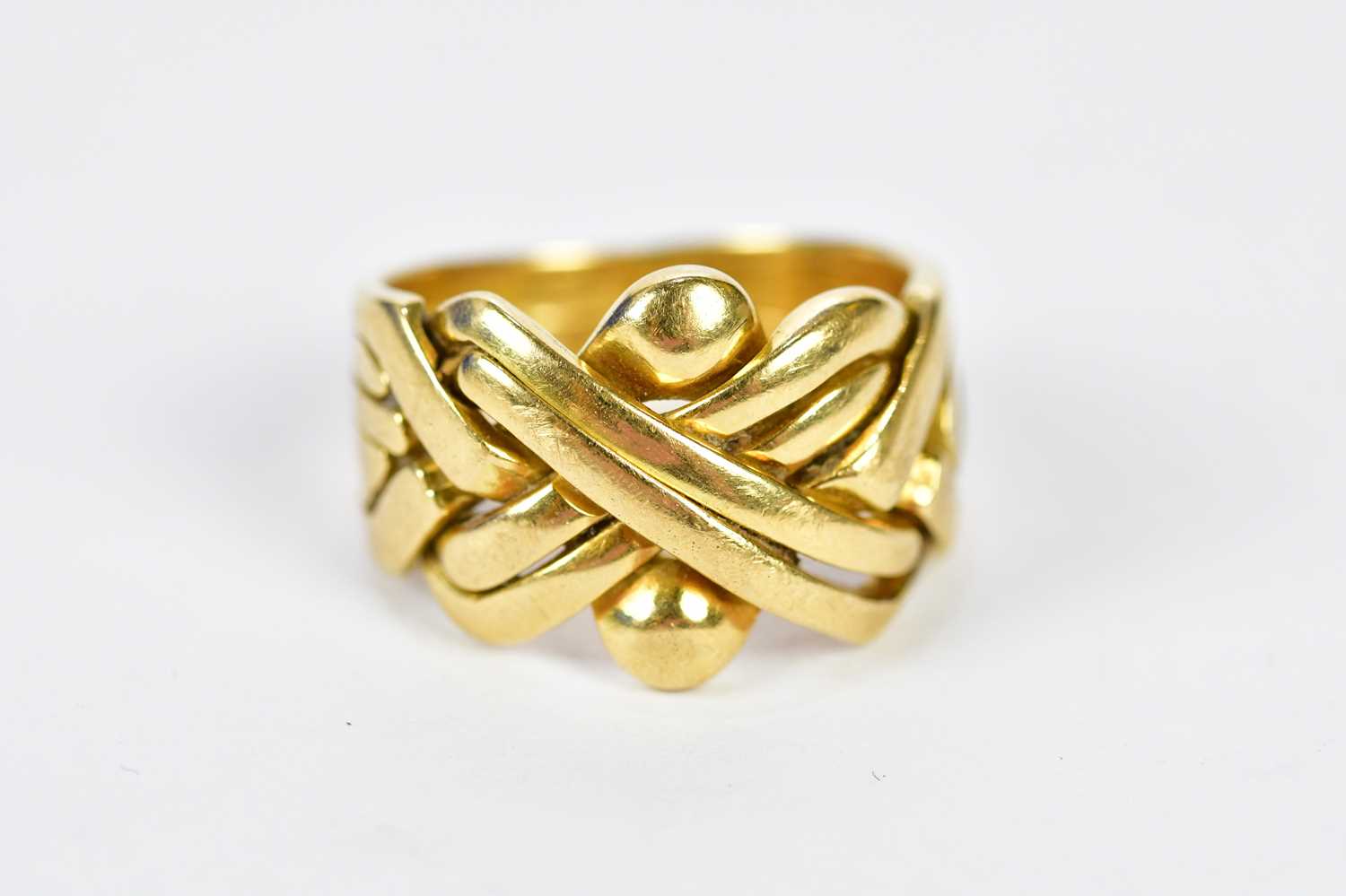 An 18ct yellow gold puzzle ring, size O, approx. 9.75g.