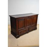 An oak mule chest, with hinged top above a panelled front with two short drawers, on bracket feet,