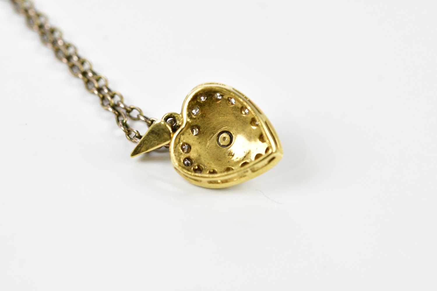 An 18ct yellow gold heart shaped pendant centred with a round brilliant cut diamond on a blue - Image 4 of 5