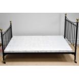 A Victorian style cast metal black painted double bed.