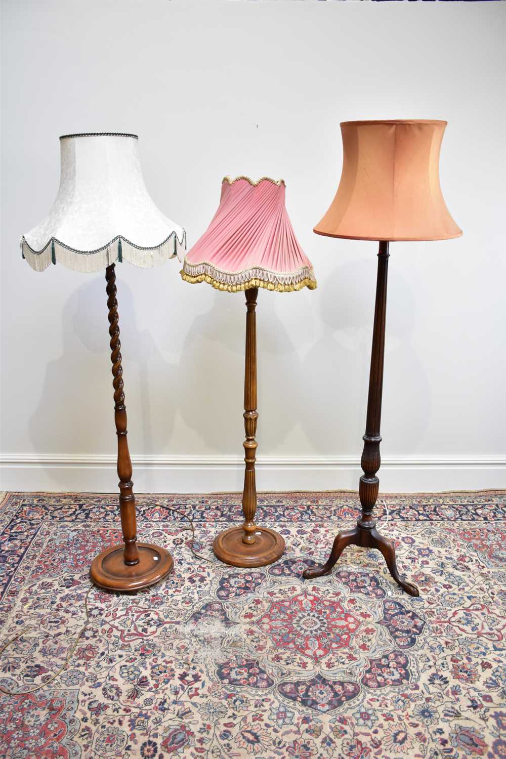 Three 20th century standard lamps, including a barley twist example, height of largest 147cm (3)