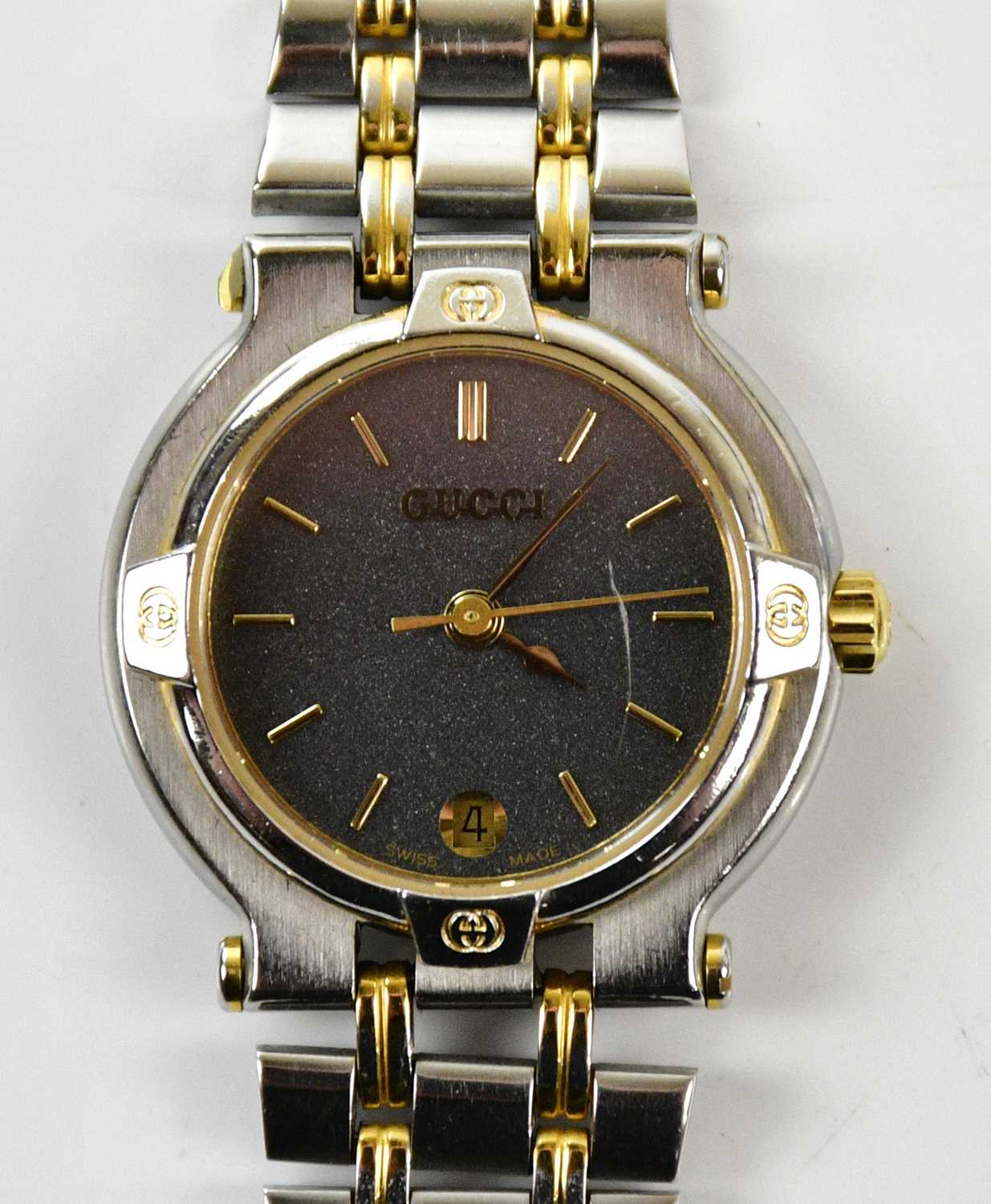 GUCCI; a vintage 9000L stainless steel and gold tone quartz wristwatch with black dial, 17cm strap