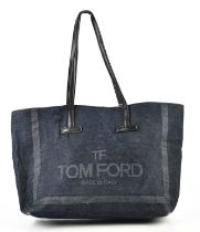 TOM FORD; a dark indigo denim tote bag with black leather top handles and internal pocket,