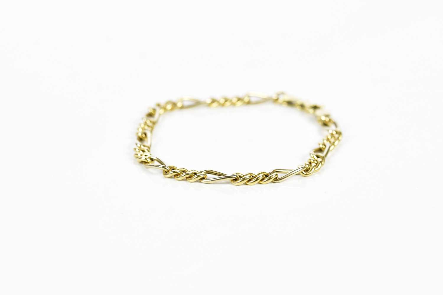 An 18ct yellow gold fetter and curb link bracelet, length 20cm, approx 7.76g.