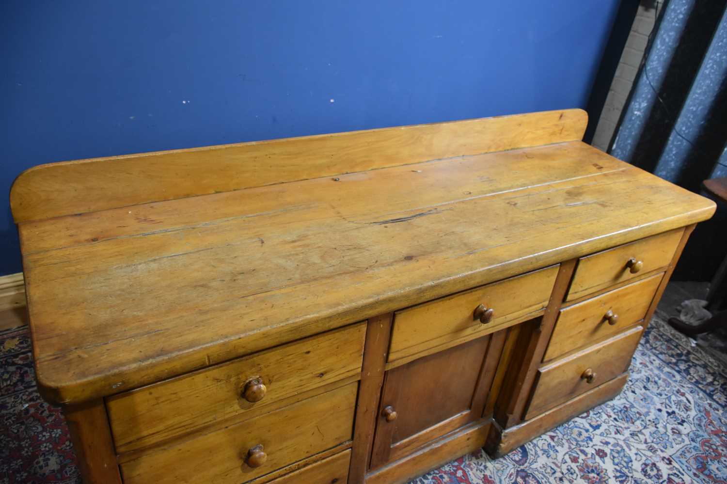 A Victorian pine dresser base with an arrangement seven drawers and panelled cupboard door on plinth - Image 2 of 4