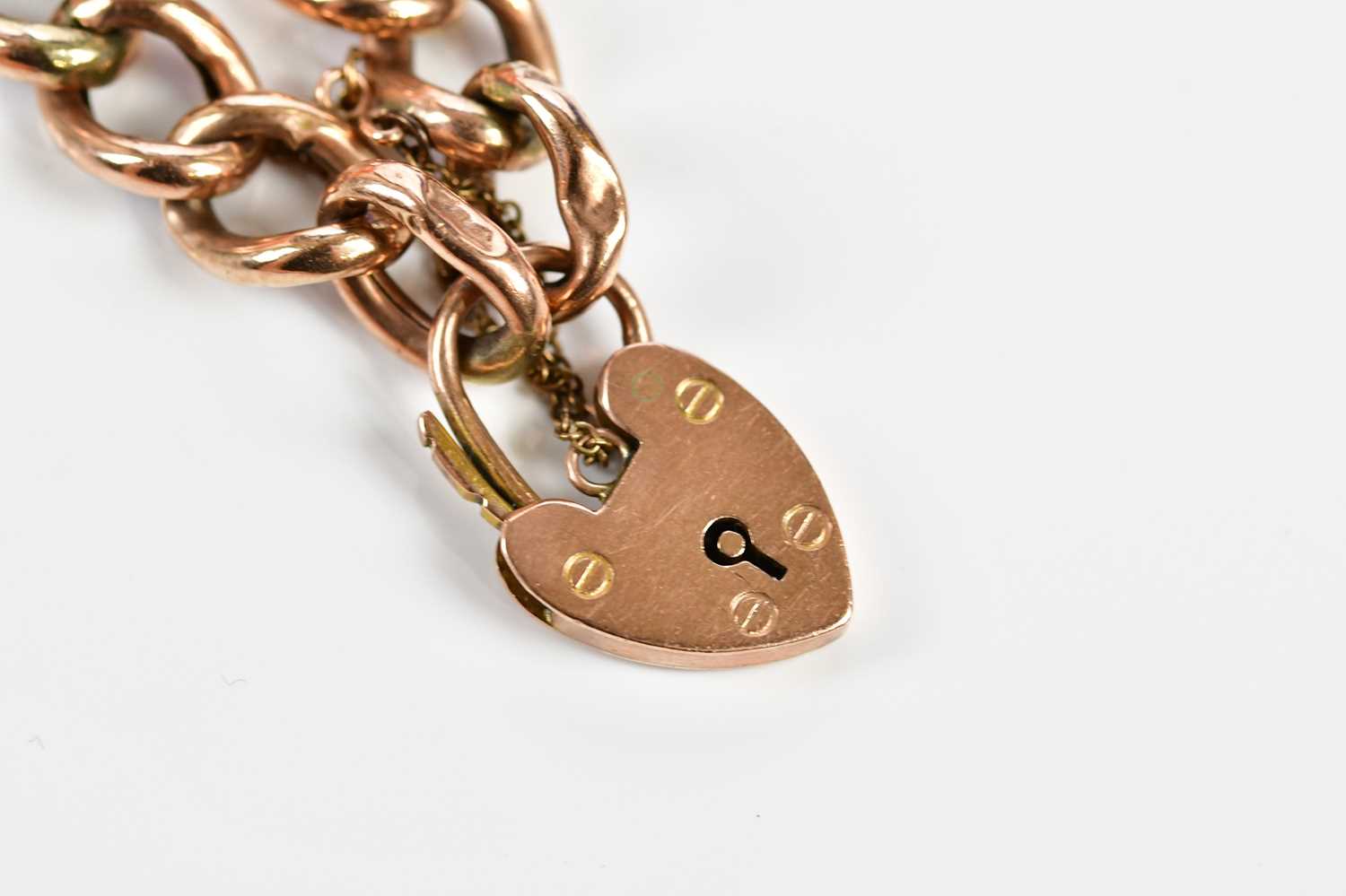 A 9ct rose gold hollow curb link bracelet with padlock and safety chain, approx. 15.85g. - Image 2 of 5