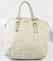 PRADA; a large cream pebbled leather handbag with top handles and detachable shoulder strap, gold