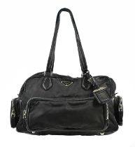 PRADA; a multi pocket Tessuto nylon and black leather handbag with silver tone hardware bag tag