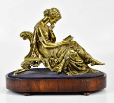 A late 19th/early 20th century gilt bronze figure of a seated lady reading, on oval wooden plinth