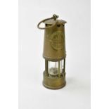 A vintage brass miner's lamp, 'The Protector Lamp & Lighting Co, Eccles, Manchester', type 6 M&Q,
