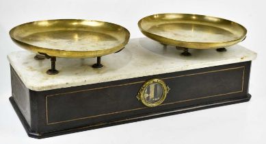 A set of late 19th/early 20th century French balance scales, with marble top and brass trays stamped