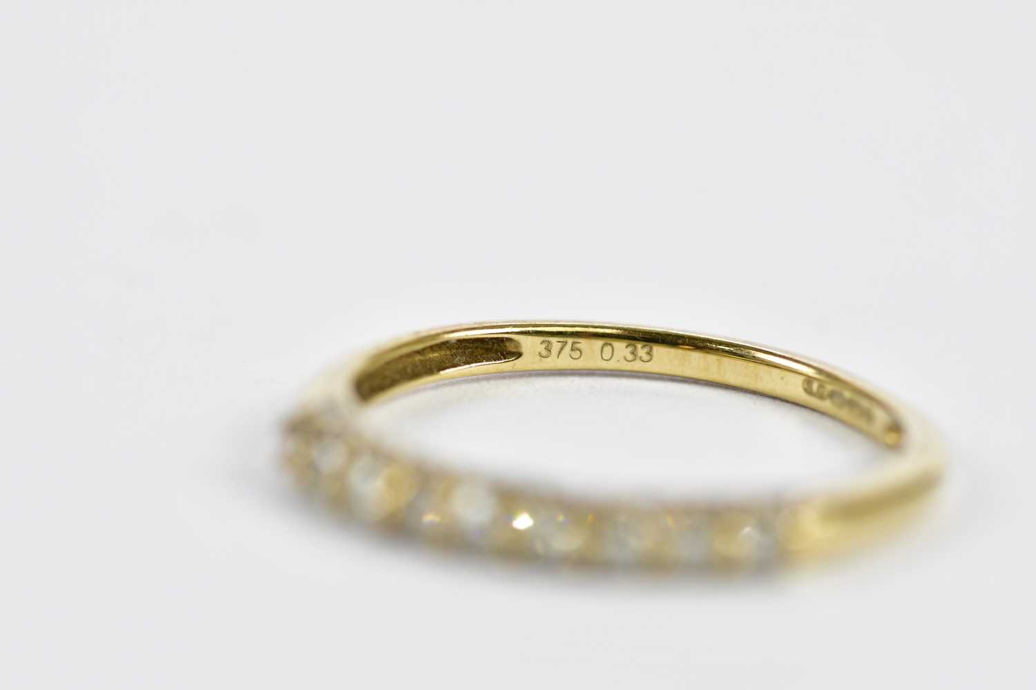 A 9ct yellow gold half eternity ring, set with nine principle stones and a melee of twnety stones, - Image 3 of 3