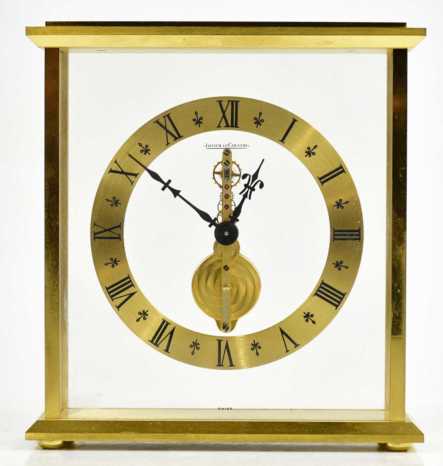 JAEGER-LECOULTRE; a gilt metal cased skeleton clock, the chapter ring set with Roman numerals,