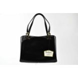WALDYBAG; a 1950s unused and boxed black leather handbag with gold tone hardware, beige suede