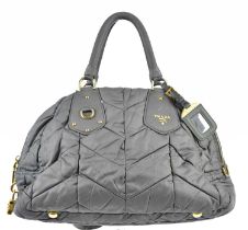 PRADA; an Ardesia grey nylon quilted handbag with gold tone hardware logo to front, buckles and zip,