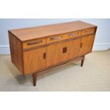 G-PLAN; a 'Fresco' range teak sideboard with three drawers above four panelled cupboard doors, on