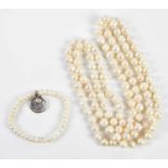 A cultured pearl hand tied necklace, length 120cm, and a pearl bracelet with disc pendant (2)