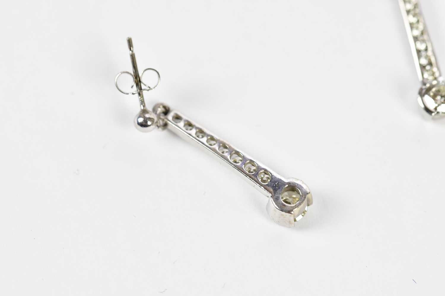 A pair of 18ct white gold diamond drop earrings, the channels set with eight tapering round - Image 4 of 4
