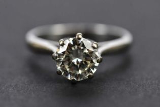 An 18ct white gold diamond solitaire ring, the eight claw set round brilliant cut stone weighing