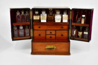 A Regency mahogany apothecary cabinet, the pair of doors enclosing an arrangement of bottles and