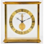 JAEGER-LECOULTRE; a gilt metal cased skeleton clock, the chapter ring set with Roman numerals,