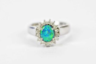 A platinum enhanced black opal and diamond oval set cluster ring, size M 1/2, approx 10.8g.