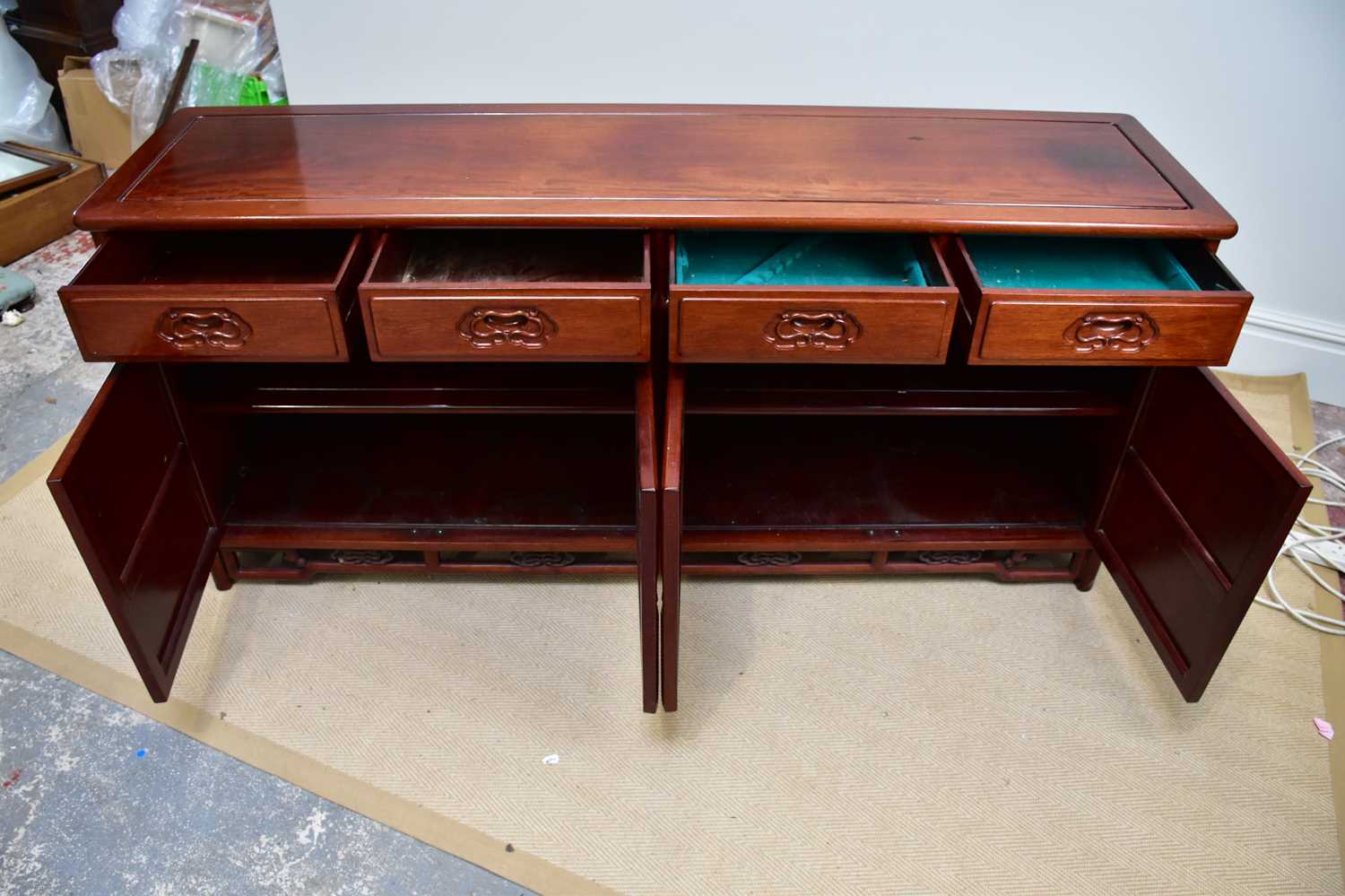 A 20th century Chinese rosewood sideboard with four drawers above four panelled cupboard doors, - Image 2 of 4