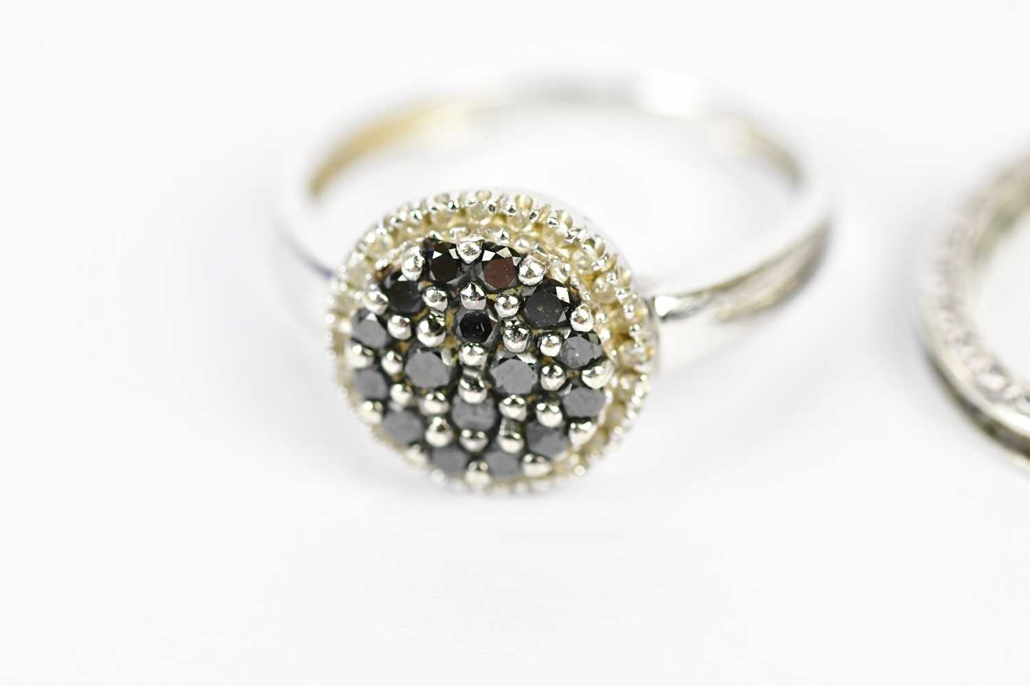 A white metal dress ring, set with dark stones, stamped 14K, size N, and a 935 grade silver eternity - Image 2 of 3