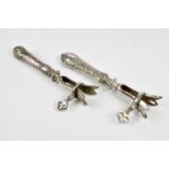 Two French white metal lamb bone holders, with foliate detailing, length 21cm (2)